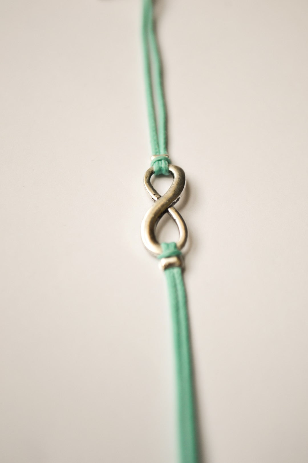 turquoise cord bracelet with a silver infinity charm - shani-adi-jewerly