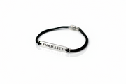 Black bracelet with 'NAMASTE' text on a white background