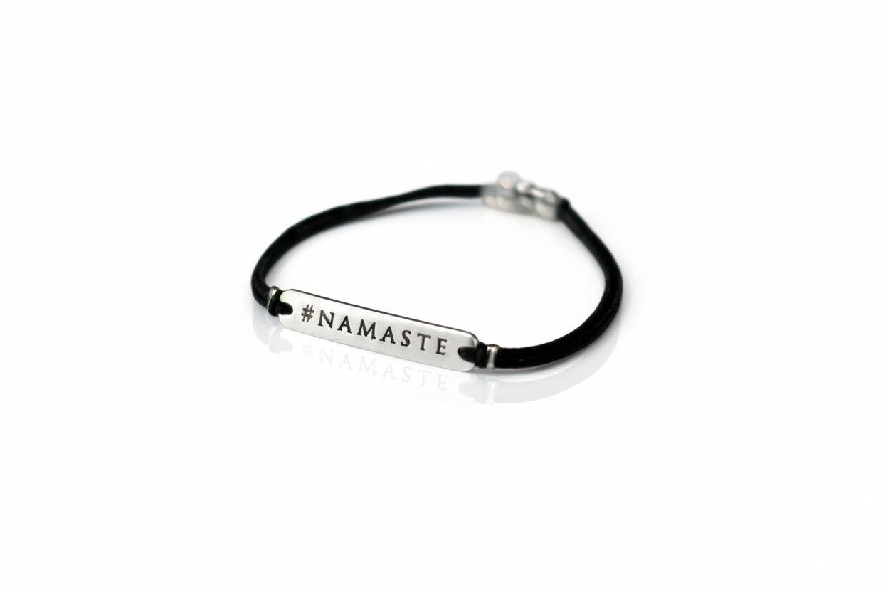 Black bracelet with 'NAMASTE' text on a white background