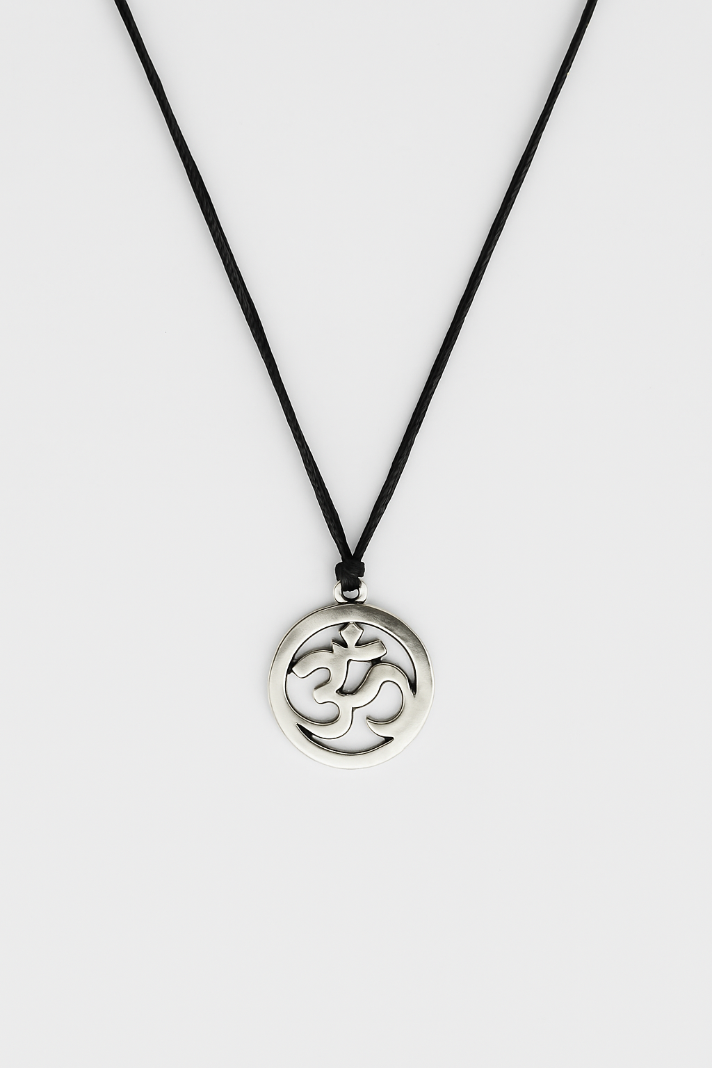 Necklace with a silver pendant featuring an Om symbol on a white background