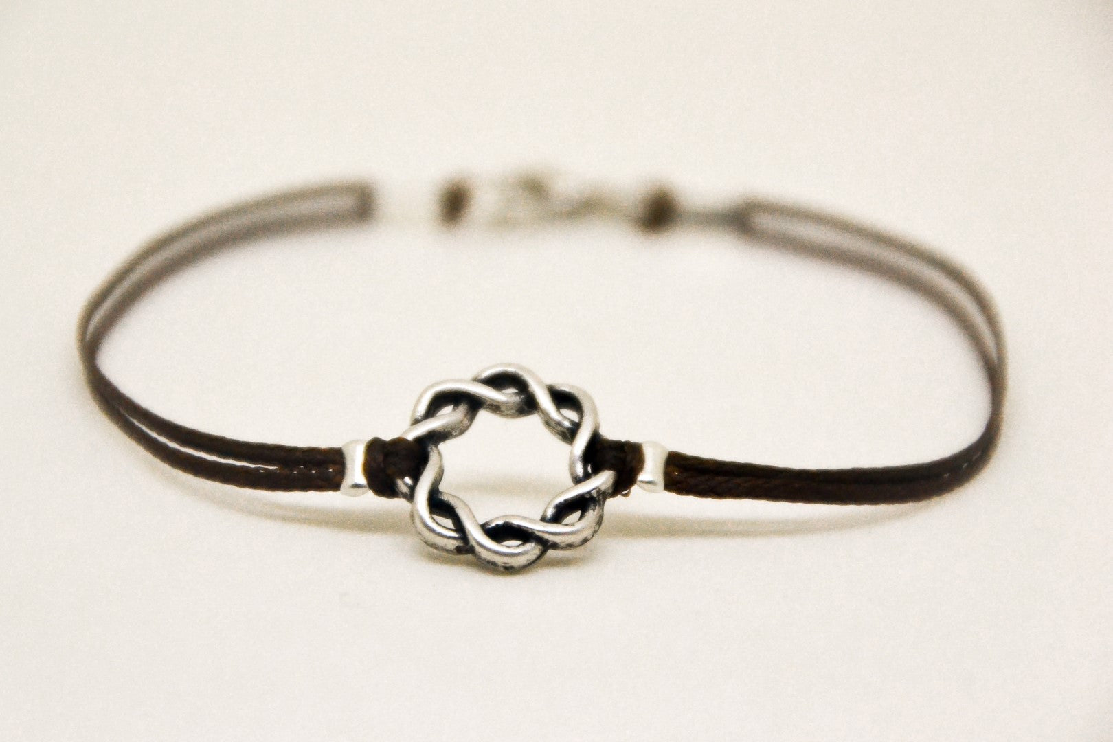 Karma bracelet for men with a silver braided circle charm, brown cord