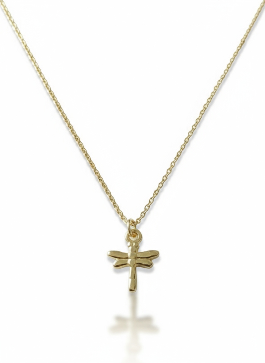 Gold necklace with a dragonfly pendant on a white background