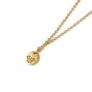 Gold necklace with a lotus pendant on a white background
