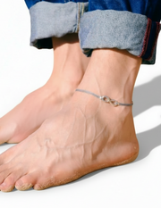 man with silver infinity anklet on a white background
