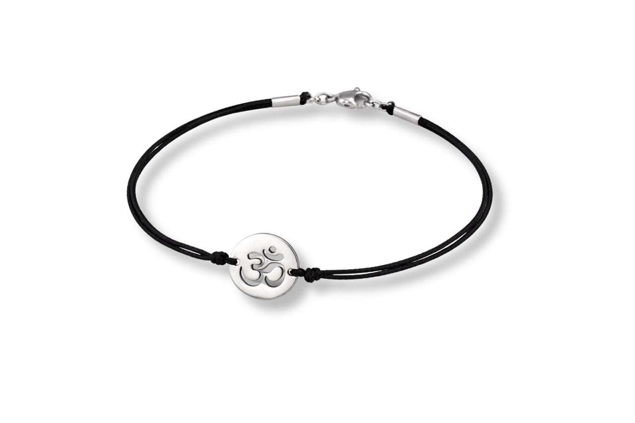 Black cord bracelet with a silver Om symbol charm on a white background