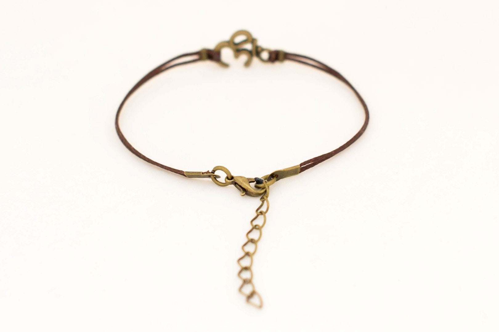 Brown cord bracelet with bronze tone Om charm, for her - shani-adi-jewerly