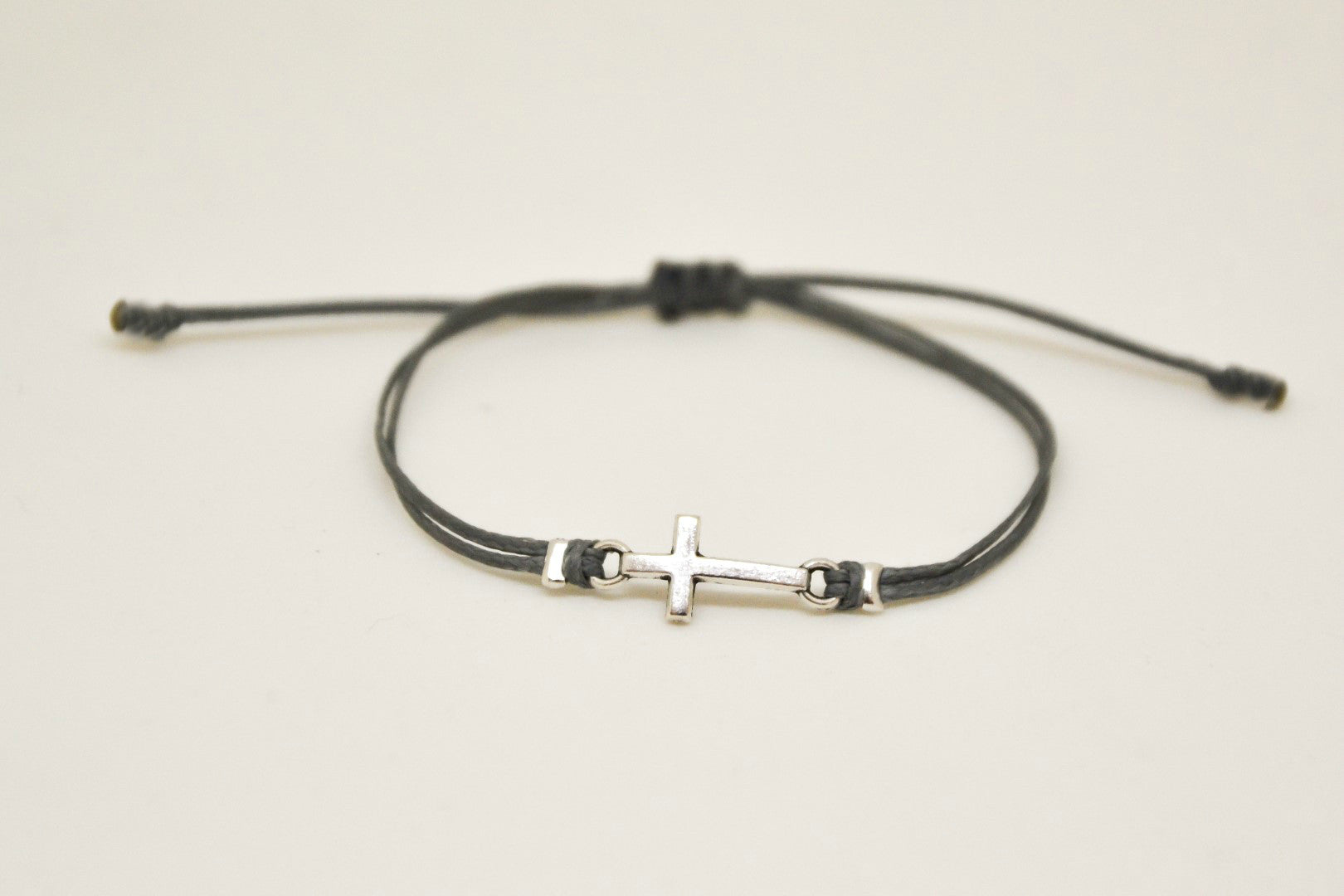 Silver cross charm bracelet, gray cord, adjustable sliding knot - shani-adi-jewerly