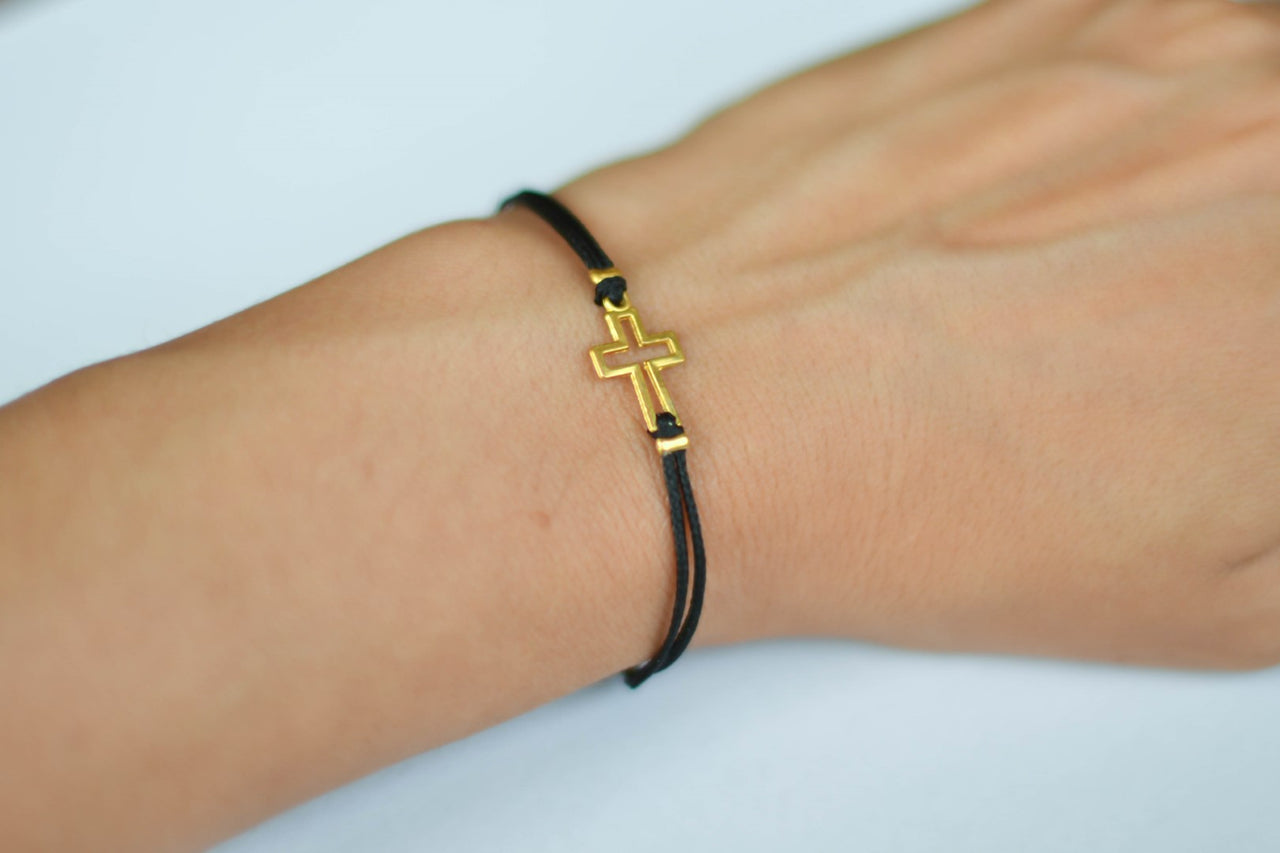 Women's bracelet with gold tone outline cross charm, black cord - shani-adi-jewerly