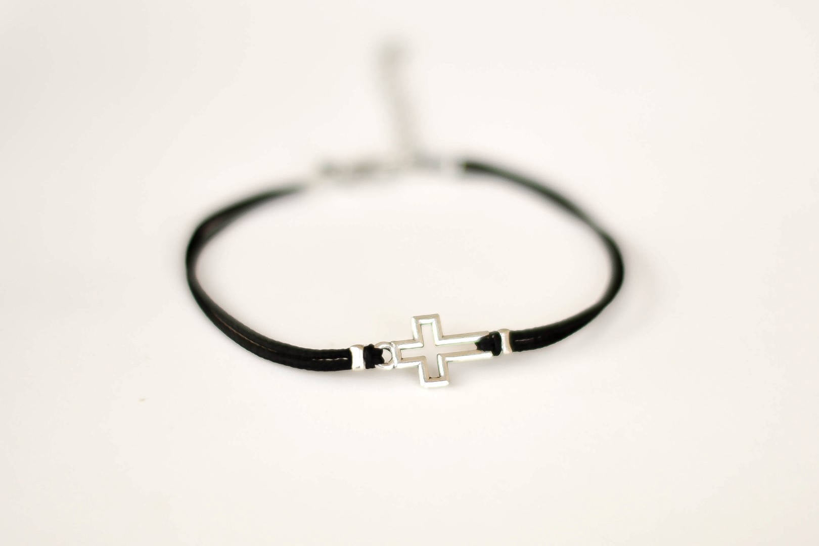 Women bracelet with silver outline cross charm, black cord - shani-adi-jewerly