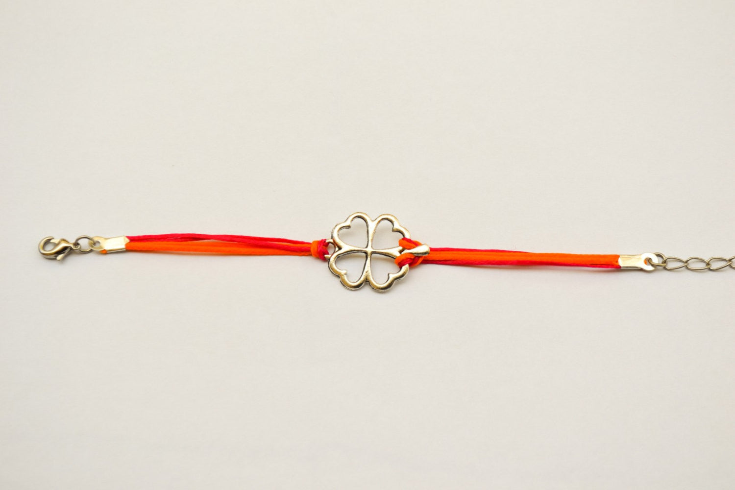 Clover bracelet - orange and pink cord bracelet with a silver shamrock charm, children's size - shani-adi-jewerly