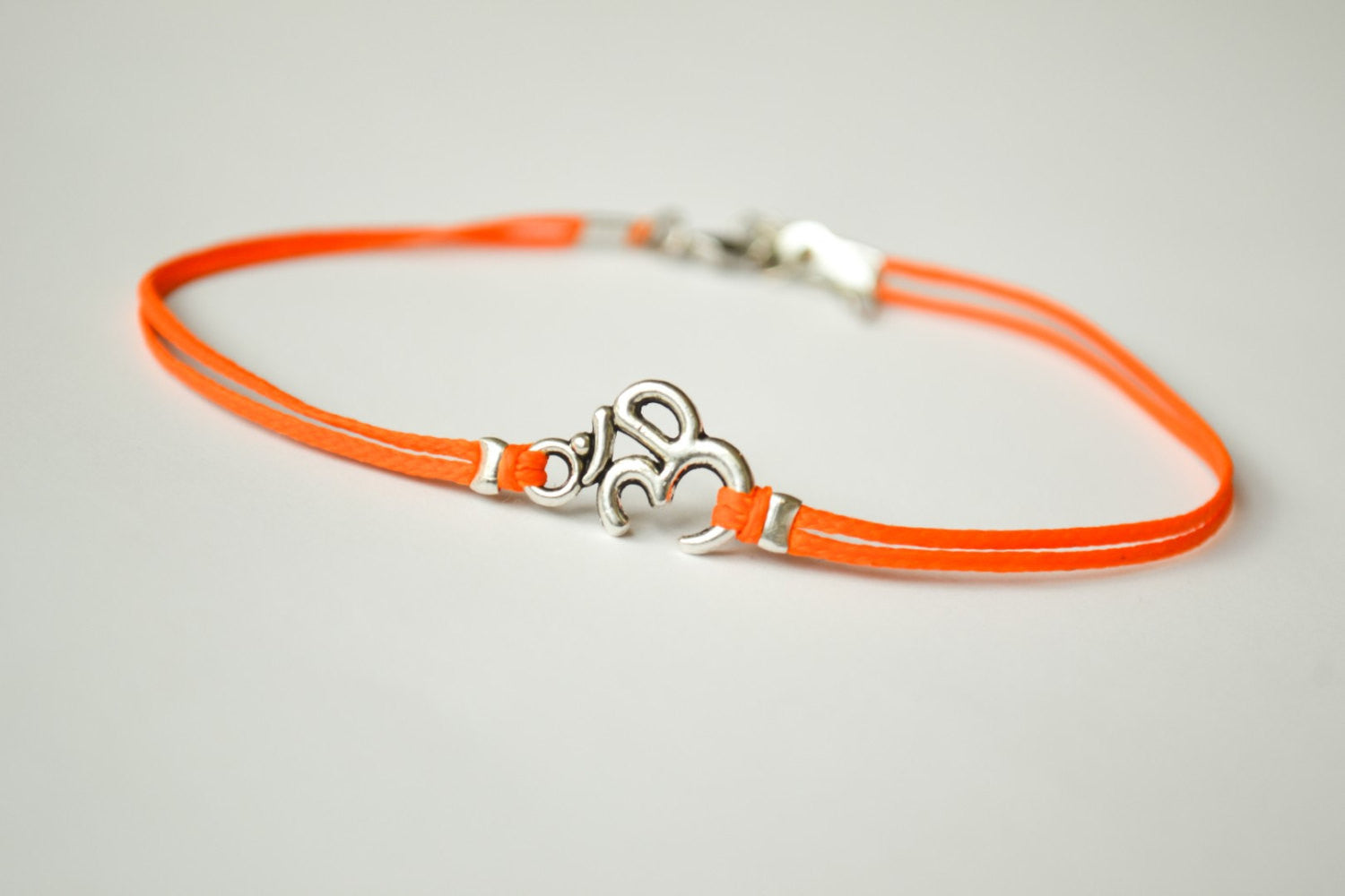 Orange cord anklet with silver Om charm - shani-adi-jewerly