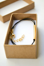Gold bar bracelet, black cord - shani-adi-jewerly