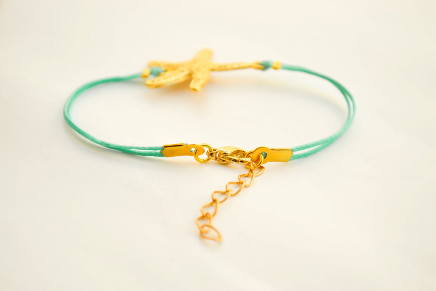 Turquoise cord bracelet with a gold sea star charm - shani-adi-jewerly