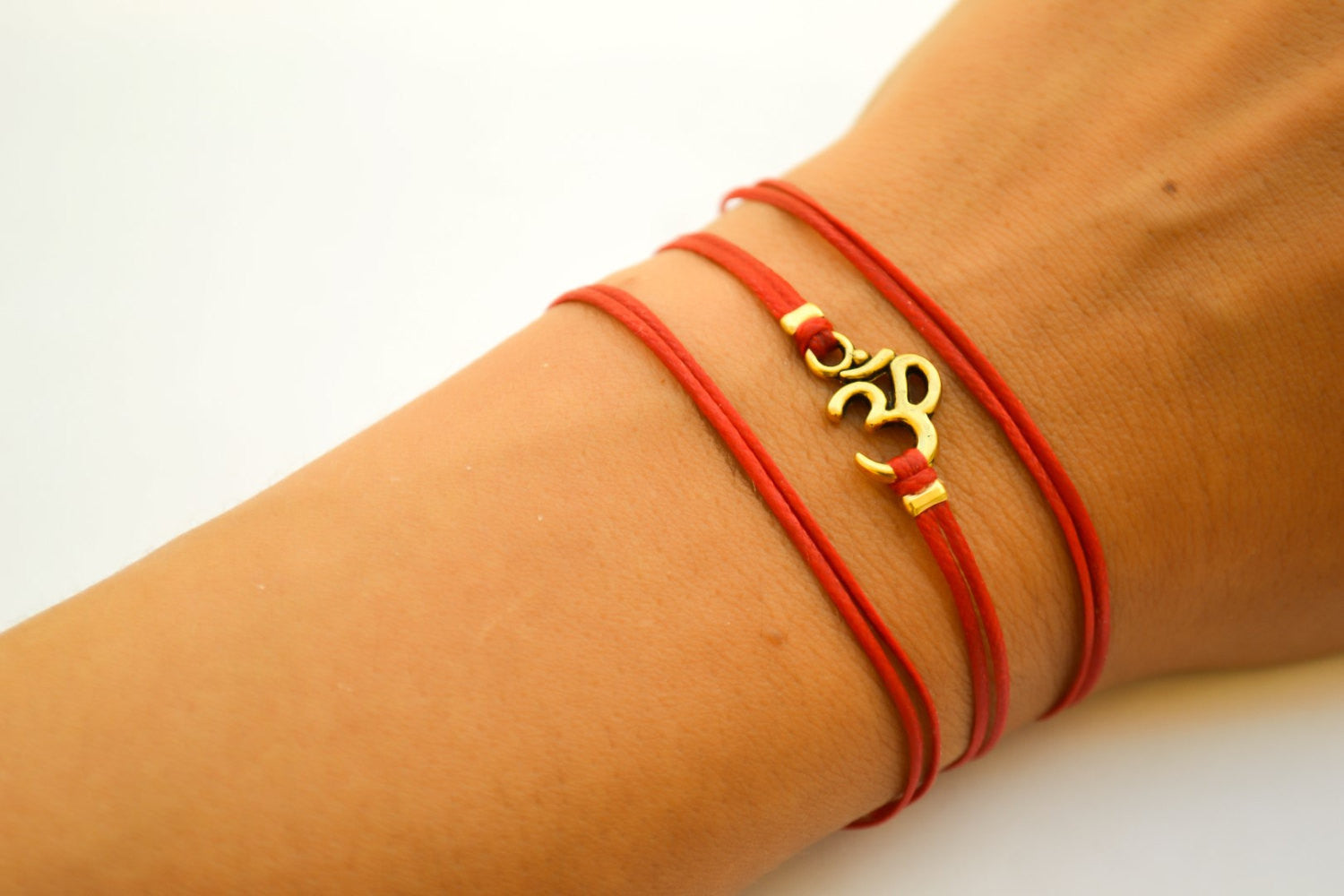 Wrapped red bracelet with gold tone Om charm - shani-adi-jewerly