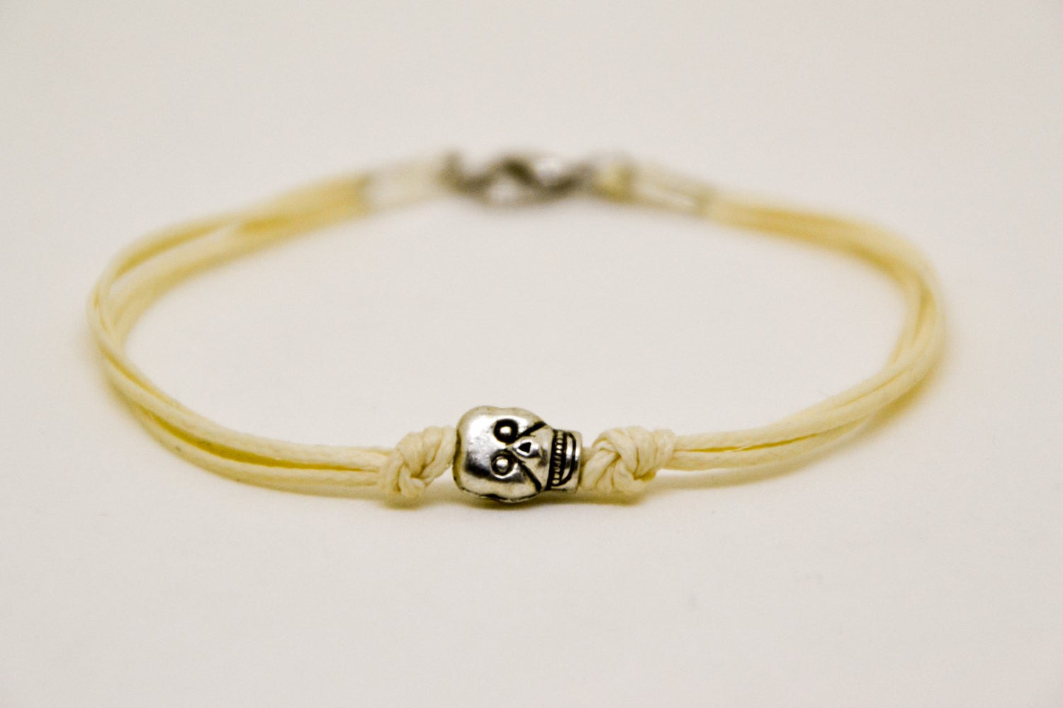 Silver skull bracelet for men, beige cord - shani-adi-jewerly