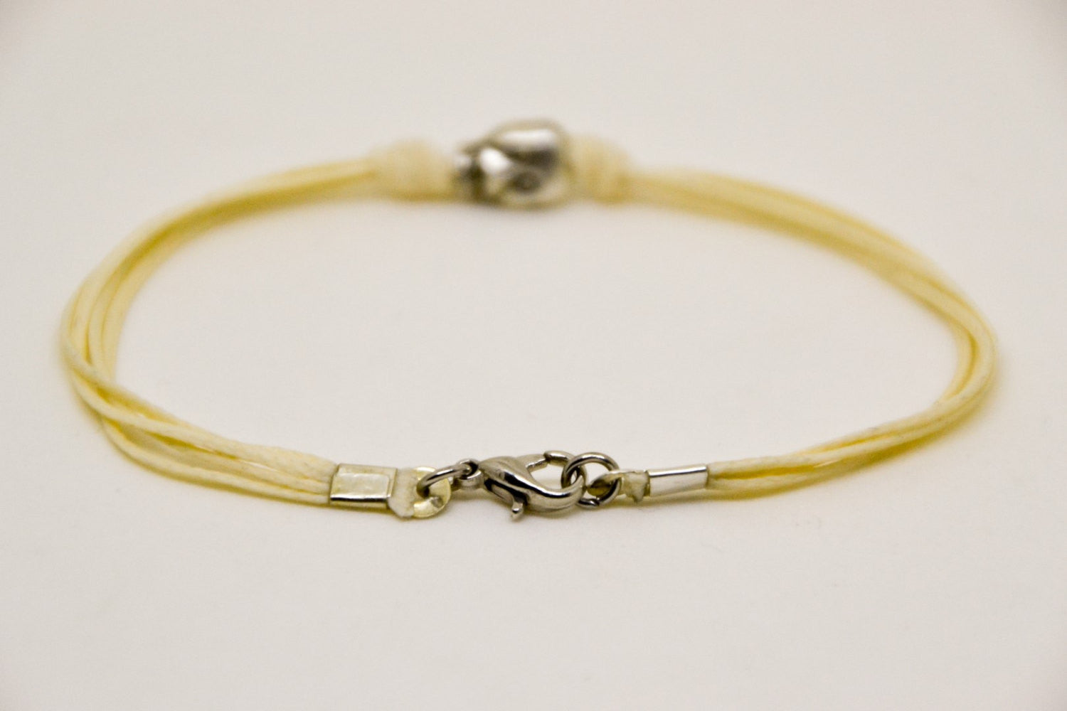 Silver skull bracelet for men, beige cord - shani-adi-jewerly