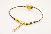 Brown cord bracelet with a 14k gold plated Ship wheel charm - shani-adi-jewerly