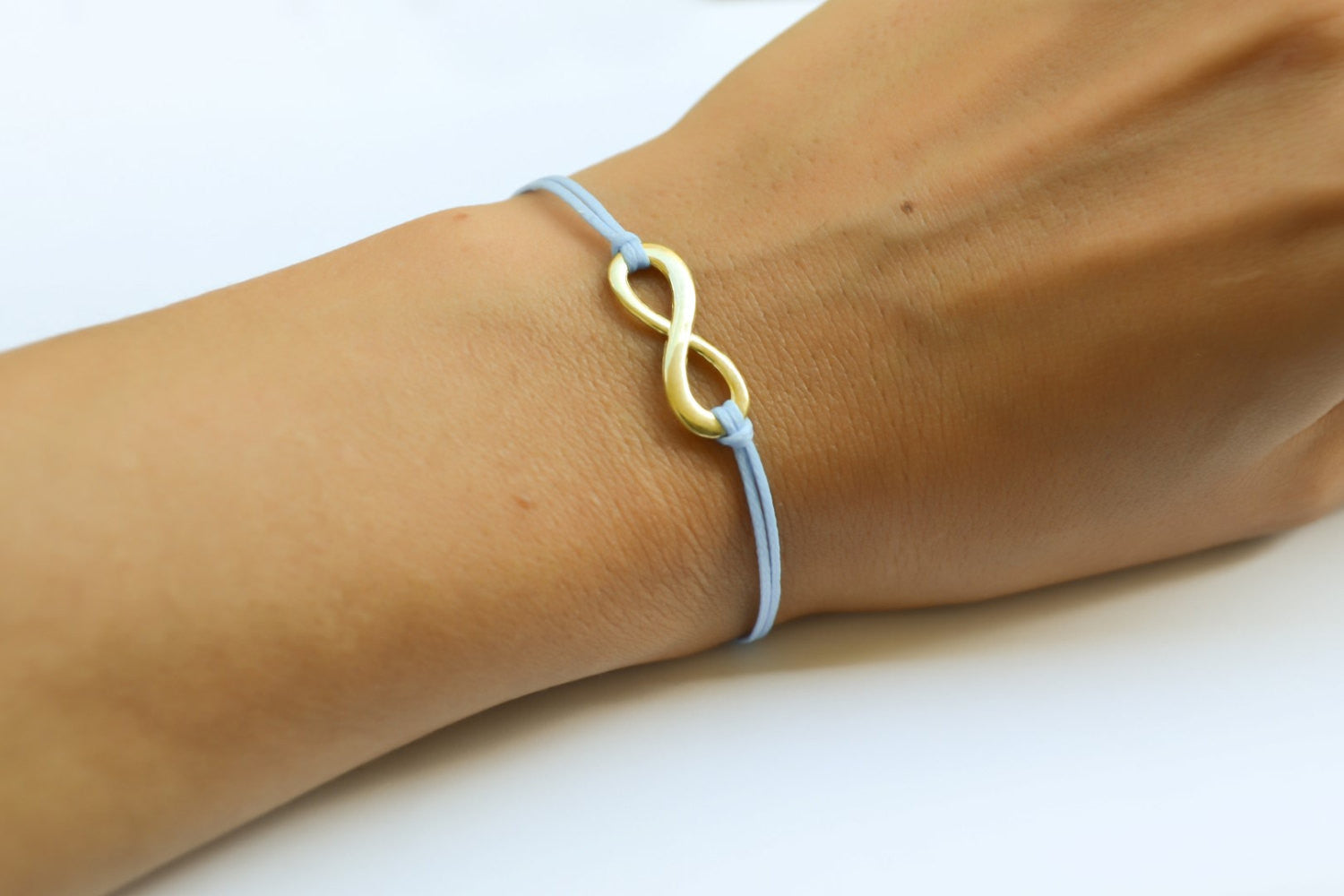 Gold infinity bracelet, womens bracelet with a blue cords, adjustable - shani-adi-jewerly