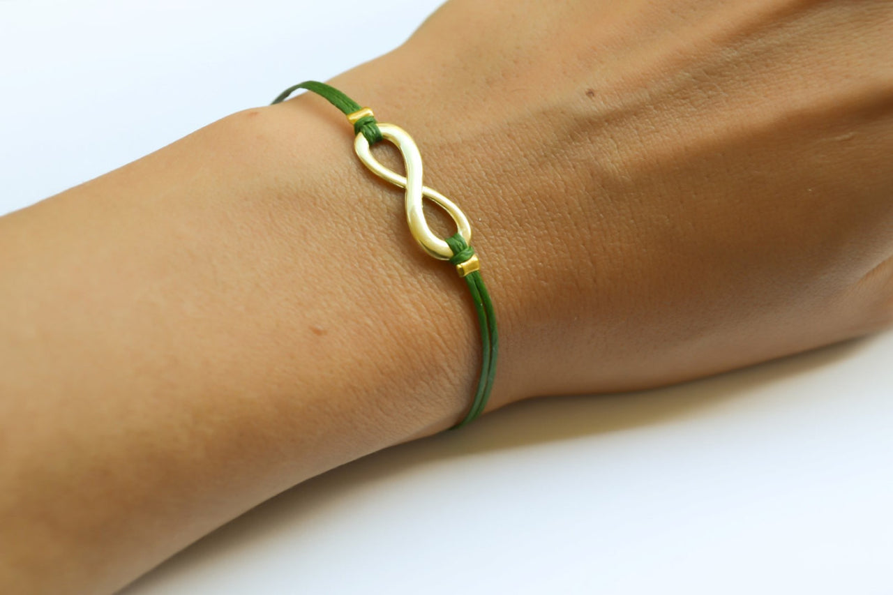 Green cord bracelet with a gold tone infinity charm - shani-adi-jewerly
