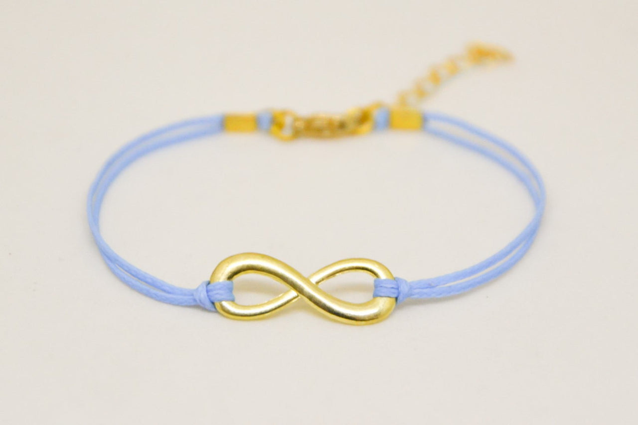 Blue cord bracelet with a gold tone endless charm - shani-adi-jewerly