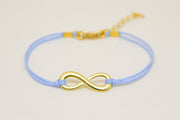 Blue cord bracelet with a gold tone endless charm - shani-adi-jewerly