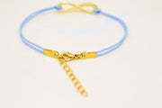 Blue cord bracelet with a gold tone endless charm - shani-adi-jewerly
