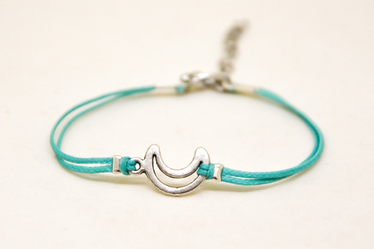 Turquoise cord bracelet with a silver crescent moon charm - shani-adi-jewerly