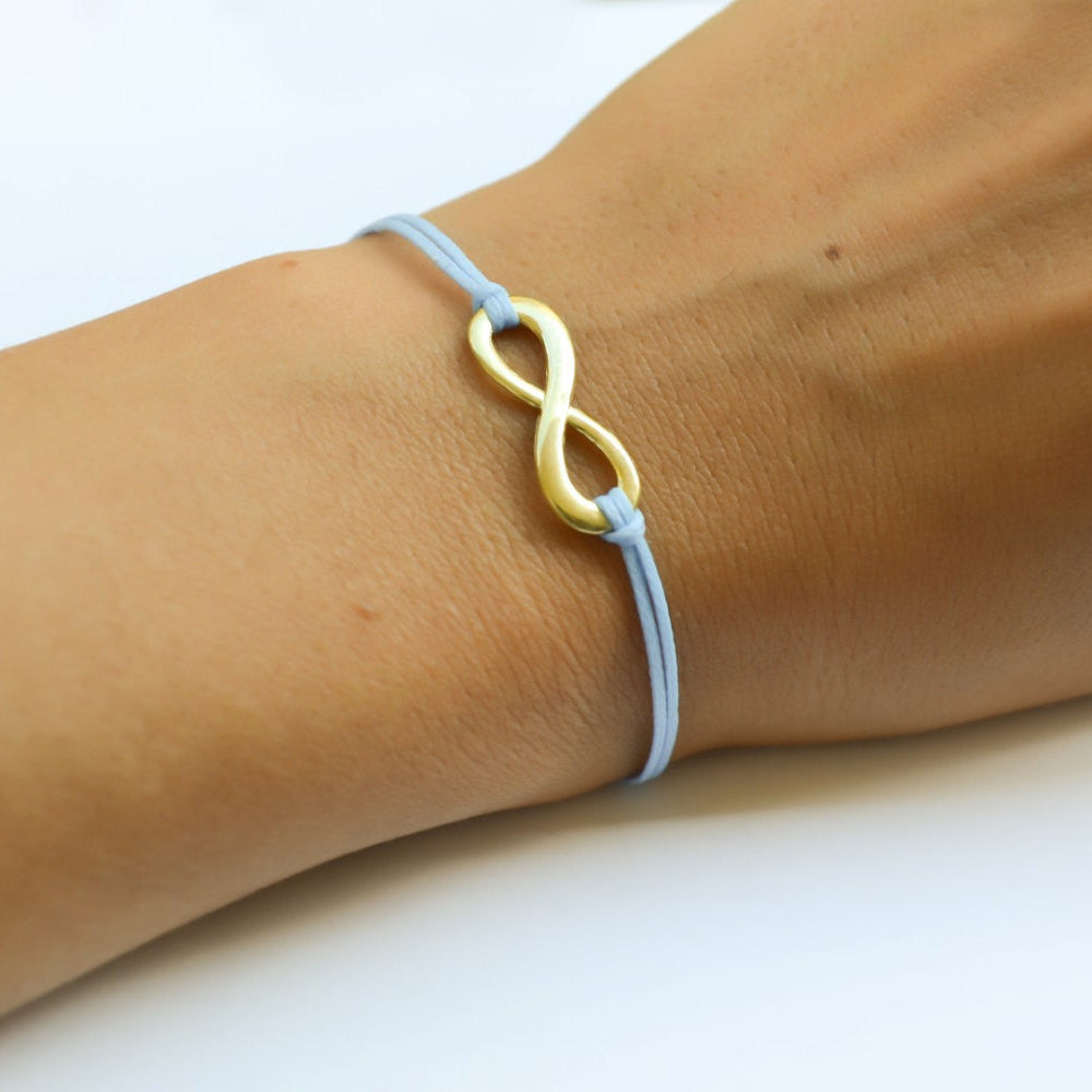 Blue cord bracelet with a gold tone endless charm - shani-adi-jewerly