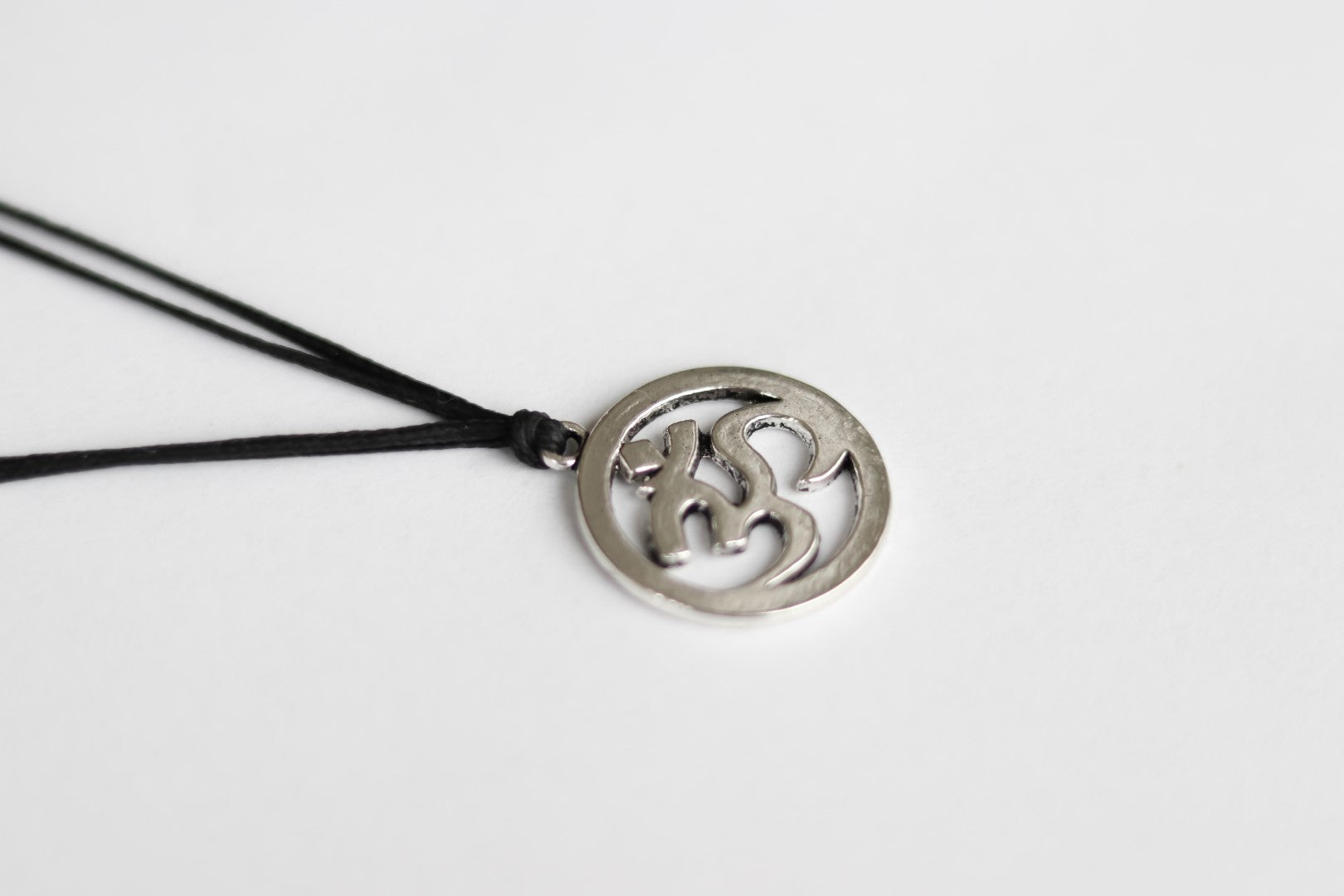 Men's necklace with a silver Om pendant, black cord - shani-adi-jewerly