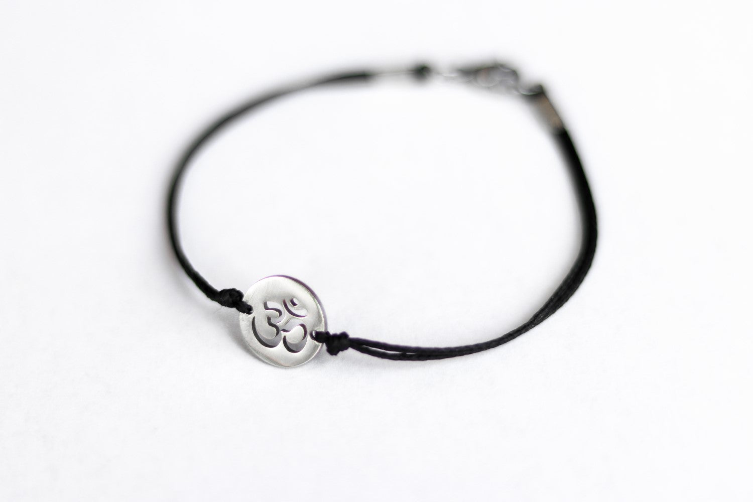 handmade silver om bracelet for men, black cord - shani and adi jewelry