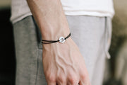 handmade silver om bracelet for men, black cord - shani and adi jewelry