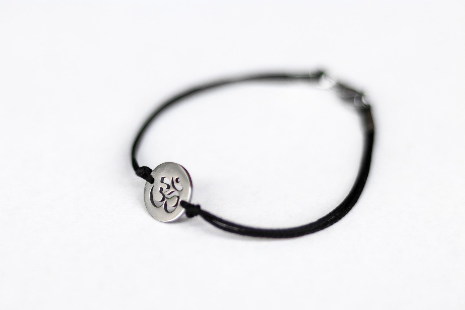 handmade silver om bracelet for men, black cord - shani and adi jewelry